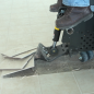 Ride-on scraper removing ceramic tile
